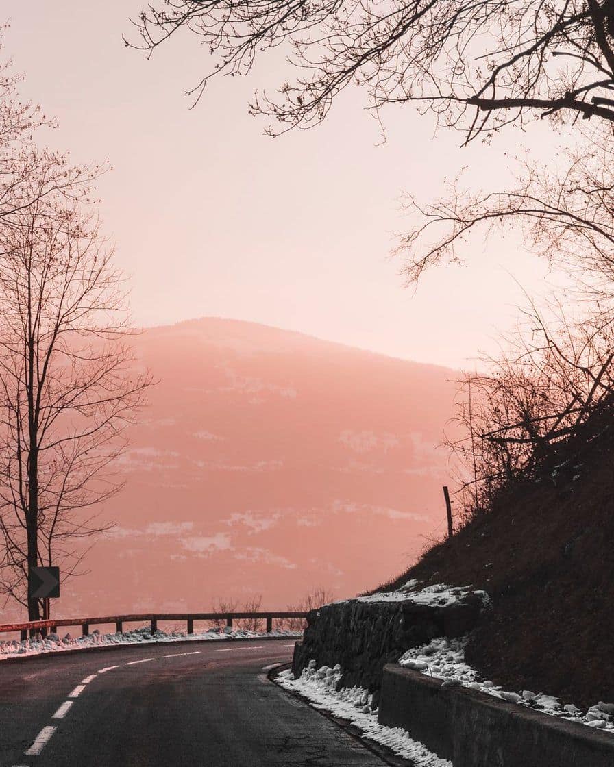 Mountain road lined with snow at sunset, in the Chamonix valley