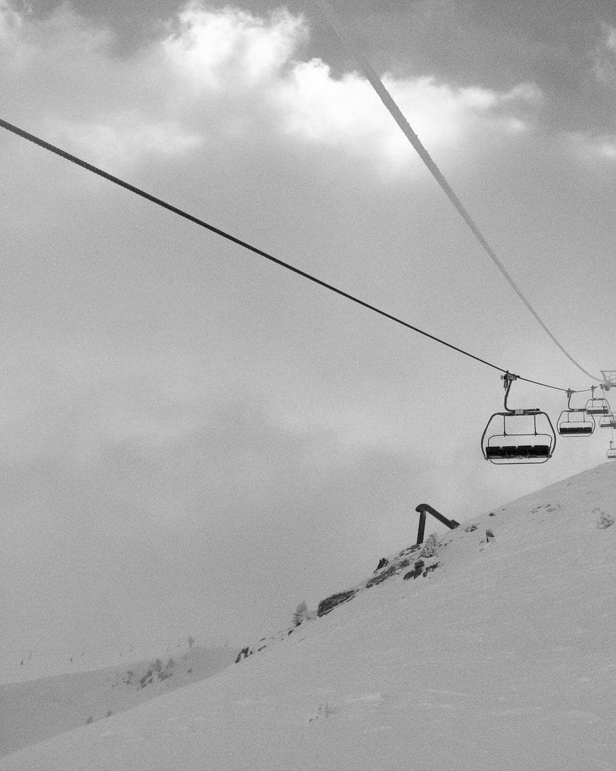 Chairlift on a snowy slope in the Chamonix valley, in black and white